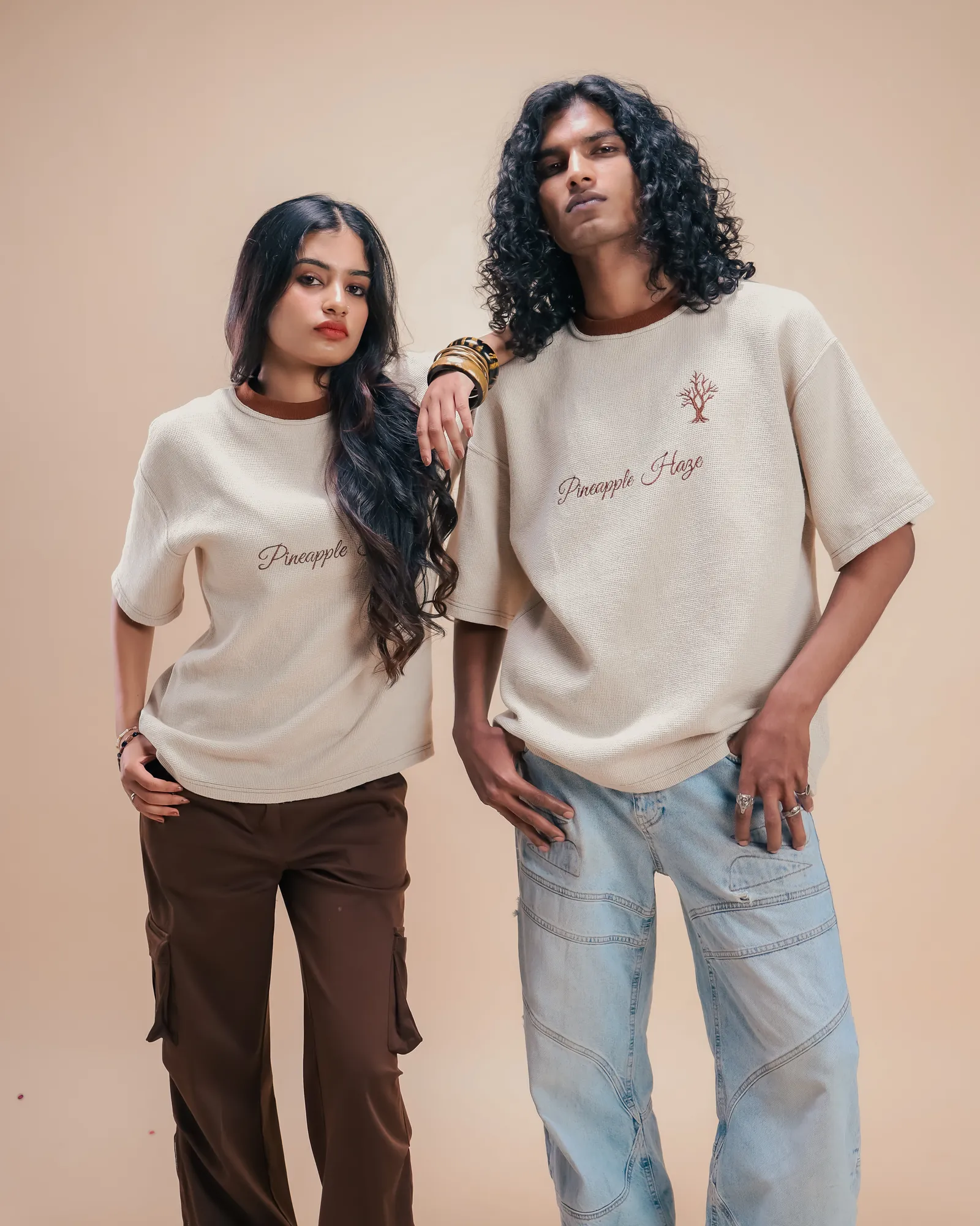 Two people standing in the Pineapple Haze tee