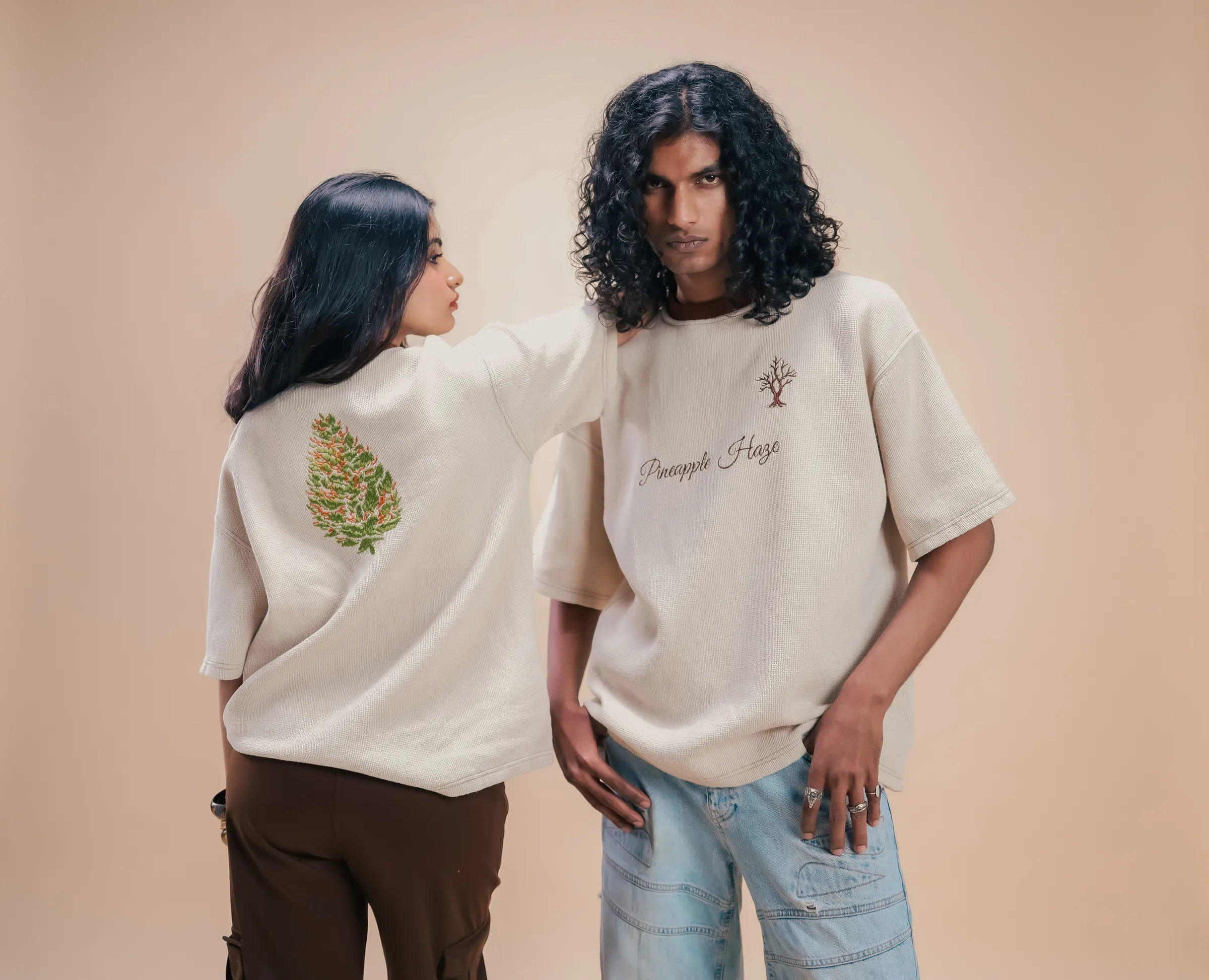 Two people in the Pineapple Haze tee, one turned to show the back